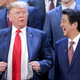 Japan’s Prime Minister (right) laughs in the vicinity of American president and unindicted co-conspirator Donald Trump on November 30, 2018 in Buenos Aires, Argentina